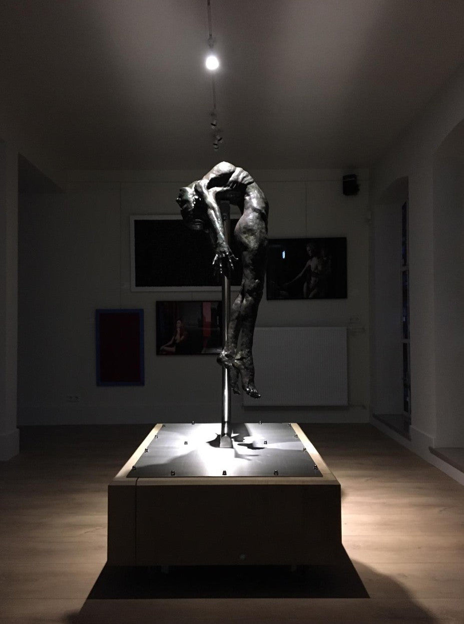 I SPIRIT by Teresa Wells – a monumental one-off bronze sculpture of a nude female figure, arched backwards in a powerful, suspended pose, supported mid-air by a sweeping stainless steel arc anchored to a stone base. Standing 190cm high, the figure’s elongated form captures anatomical detail, strength, and vulnerability, with a dark patinated bronze finish that contrasts against the polished steel support. A contemporary statement of transformation and human resilience.