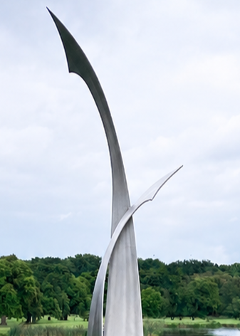 Ian Marlow MRSS stainless steel sculpture Rising Together, featuring two tall, sweeping abstract forms that curve upwards and meet within an elegant contemporary composition, displayed outdoors within a landscaped garden setting.