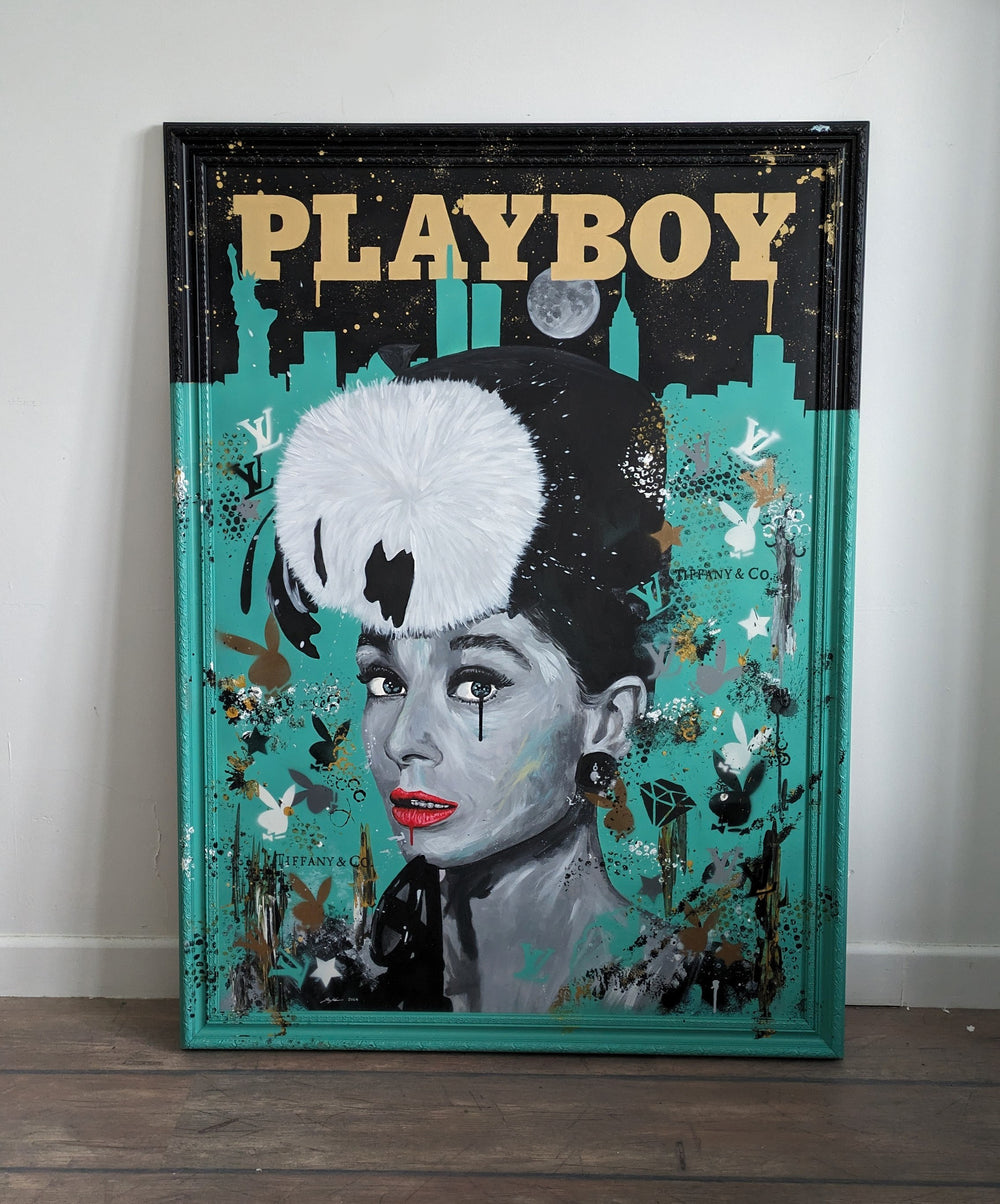 Original painting of Audrey Hepburn by Ian Salmon, featuring a monochrome portrait with vivid red lips and a bold white fur hat, set against a Tiffany blue background with the New York skyline, gold "Playboy" title, and luxury brand motifs.