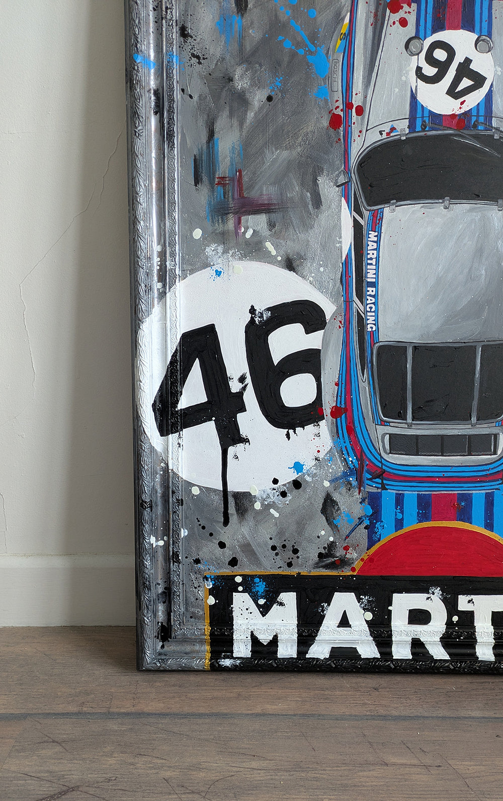 Original painting of a 1973 Porsche 911 Carrera 3.0 RSR in Martini Racing livery, shown from a top-down view with bold racing stripes and number 46, set against a textured abstract grey background and framed in a custom-painted frame.