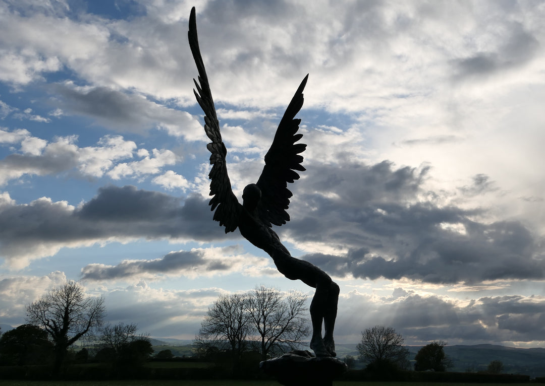 “Icarus X” by Nicola Godden – a limited edition bronze sculpture depicting Icarus falling from the sky, his wings extended in descent. Cast with a blue ocean-inspired patina, this handmade British bronze captures both tragedy and grace.