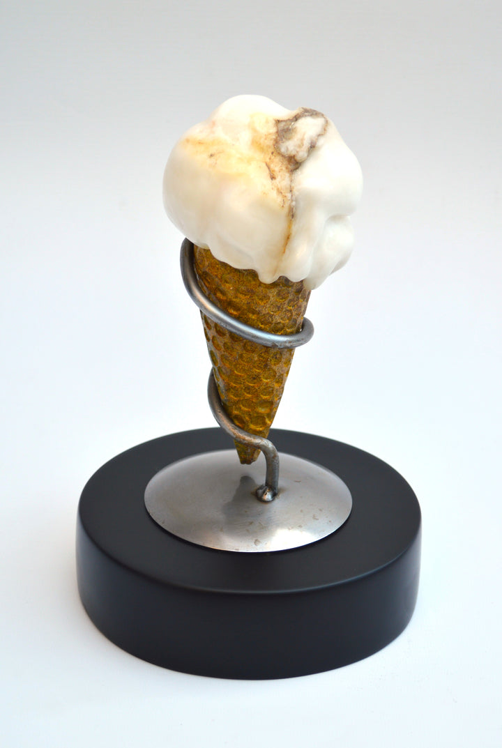 Deborah Harrison alabaster sculpture Ice Cream, one-off artwork featuring a hand-carved alabaster scoop with natural cream and golden brown veining, set in an Ancaster limestone cone, secured by a polished steel spiral holder on a slate base, blending playfulness with fine craftsmanship.