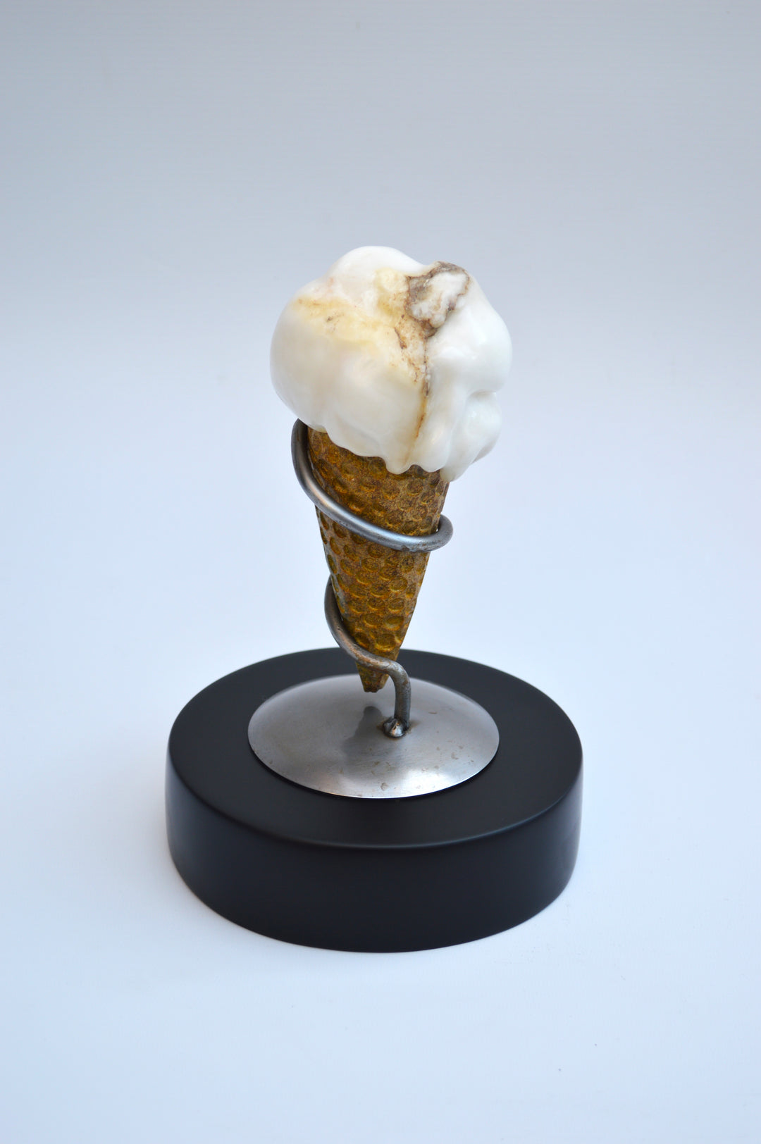 Deborah Harrison alabaster sculpture Ice Cream, one-off artwork featuring a hand-carved alabaster scoop with natural cream and golden brown veining, set in an Ancaster limestone cone, secured by a polished steel spiral holder on a slate base, blending playfulness with fine craftsmanship.