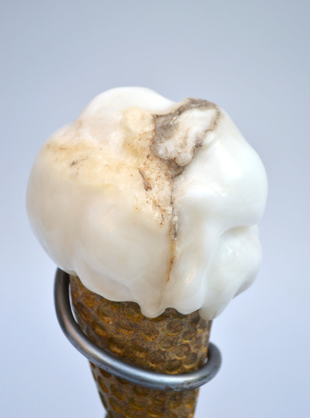 Deborah Harrison alabaster sculpture Ice Cream, one-off artwork featuring a hand-carved alabaster scoop with natural cream and golden brown veining, set in an Ancaster limestone cone, secured by a polished steel spiral holder on a slate base, blending playfulness with fine craftsmanship.