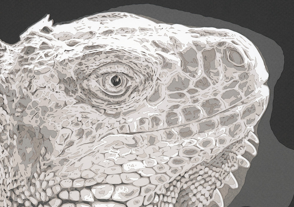 Hand-cut paper artwork of an iguana, showcasing its intricate scales and textured ridges in layered tones of ivory, taupe, and soft grey. Each scale is individually cut, creating a strikingly lifelike, prehistoric presence against a deep charcoal background.