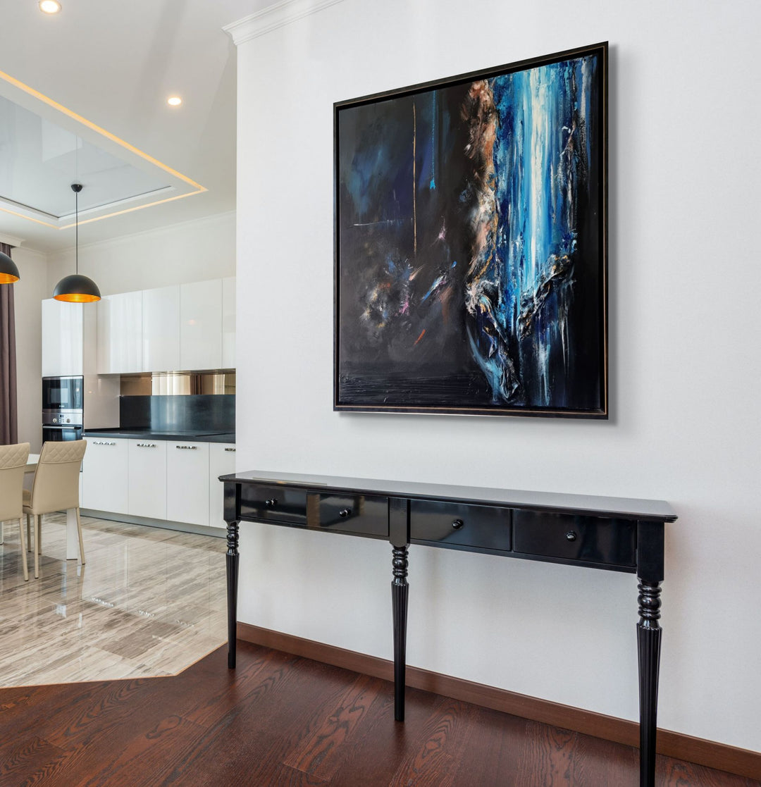 Abstract mixed-media painting in deep blues and blacks with cascading vertical textures, bright aqua highlights and metallic gold accents, featuring layered fabric elements that create a sense of movement and depth against a dark atmospheric background.