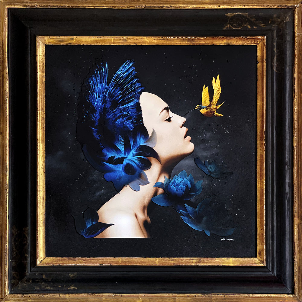 Catarina Diaz’s I See, an analogue collage on Somerset Enhanced Velvet with oil on canvas board. A serene female profile adorned with vivid blue feathers and lotus blooms faces a golden-yellow hummingbird, all set against a starry black backdrop in an antique gallery frame.