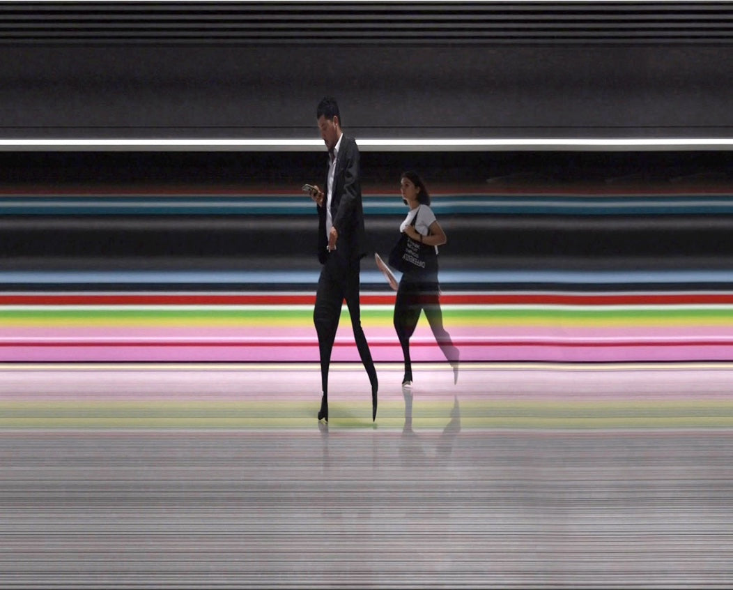 A sequence of digitally reconstructed images capturing Istanbul’s metro commuters in motion against vividly striped and graffiti-covered train carriages—where bodies blur into streaks of colour, revealing the rhythm of a city suspended between tradition and hyper-modernity.