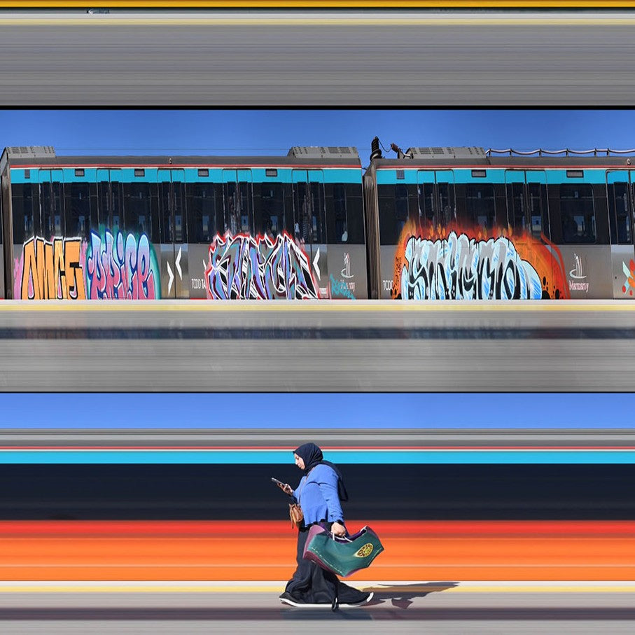 Richard P Jones Istanbul Metro #2 fine art photographic print showing layered metro trains passing along an elevated track with graffiti-covered platforms, created from reconstructed high-speed video imagery and printed as a giclée on brushed aluminium.