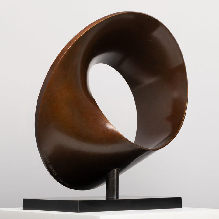 Patinated bronze Continuum sculpture by James Parker, formed as a flowing Möbius loop with a continuous twisting surface and crescent-like profile.