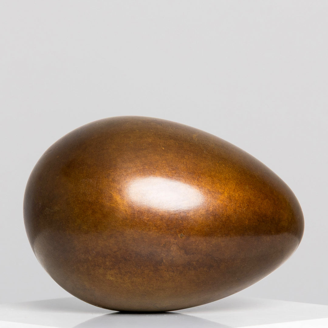 Patinated bronze Creation egg sculpture by James Parker, with a smooth rounded form symbolising fragility, containment, potential and birth.