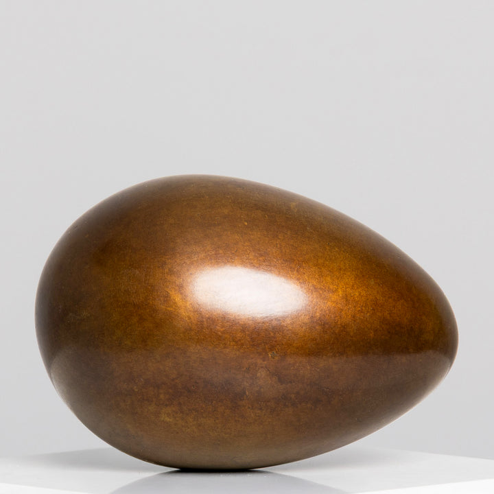 Patinated bronze Creation egg sculpture by James Parker, with a smooth rounded form symbolising fragility, containment, potential and birth.