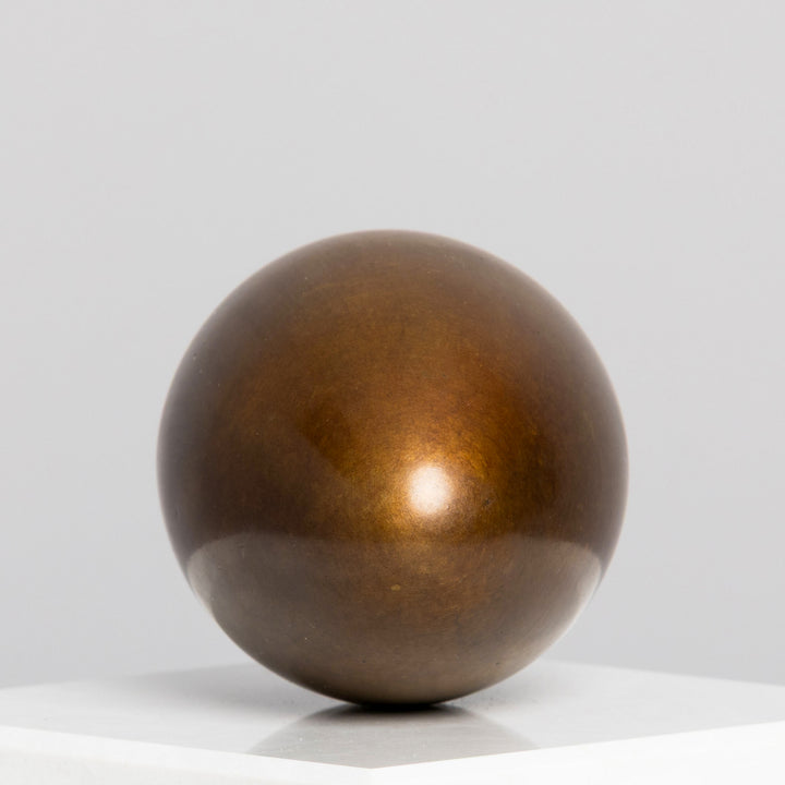 Patinated bronze Creation egg sculpture by James Parker, with a smooth rounded form symbolising fragility, containment, potential and birth.
