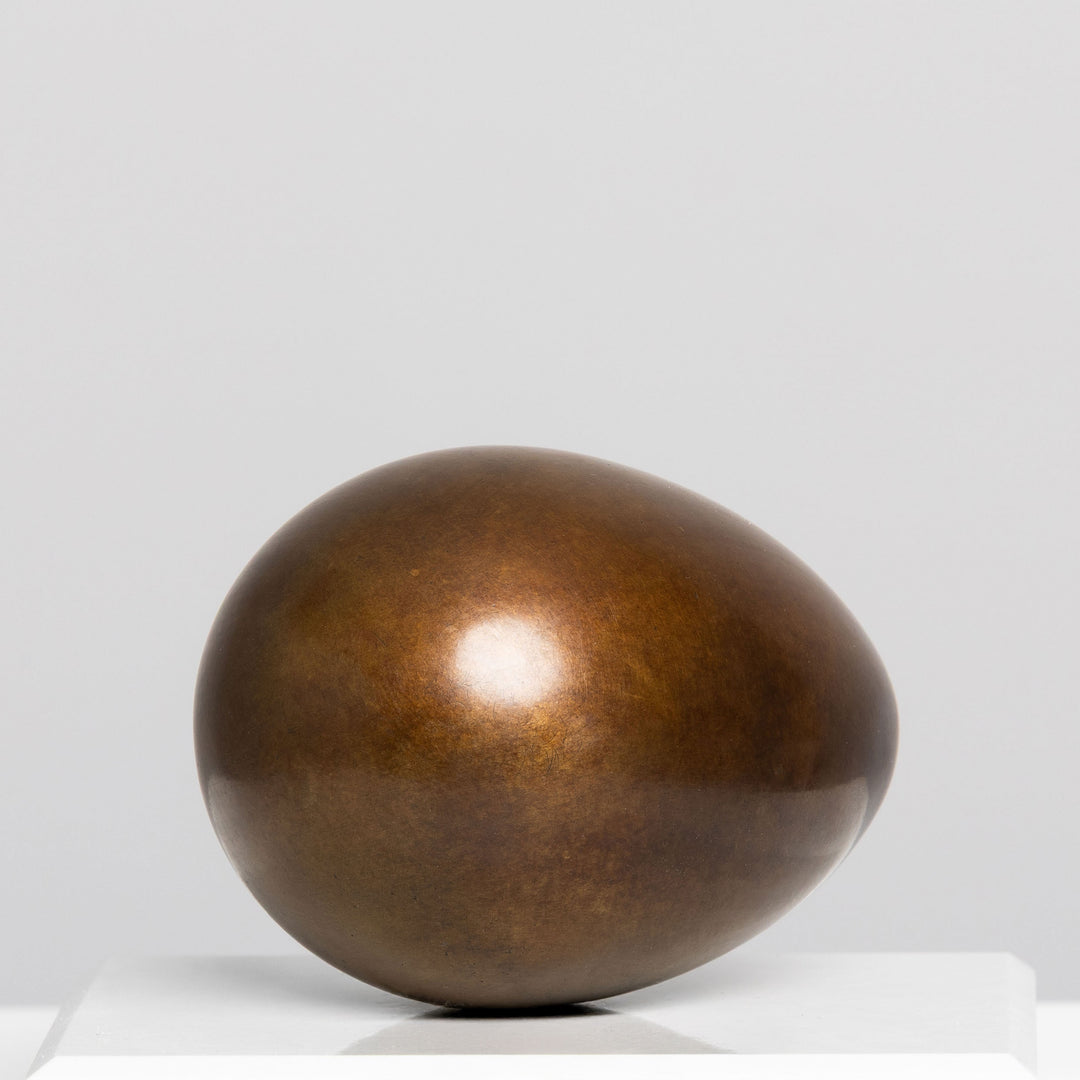 Patinated bronze Creation egg sculpture by James Parker, with a smooth rounded form symbolising fragility, containment, potential and birth.