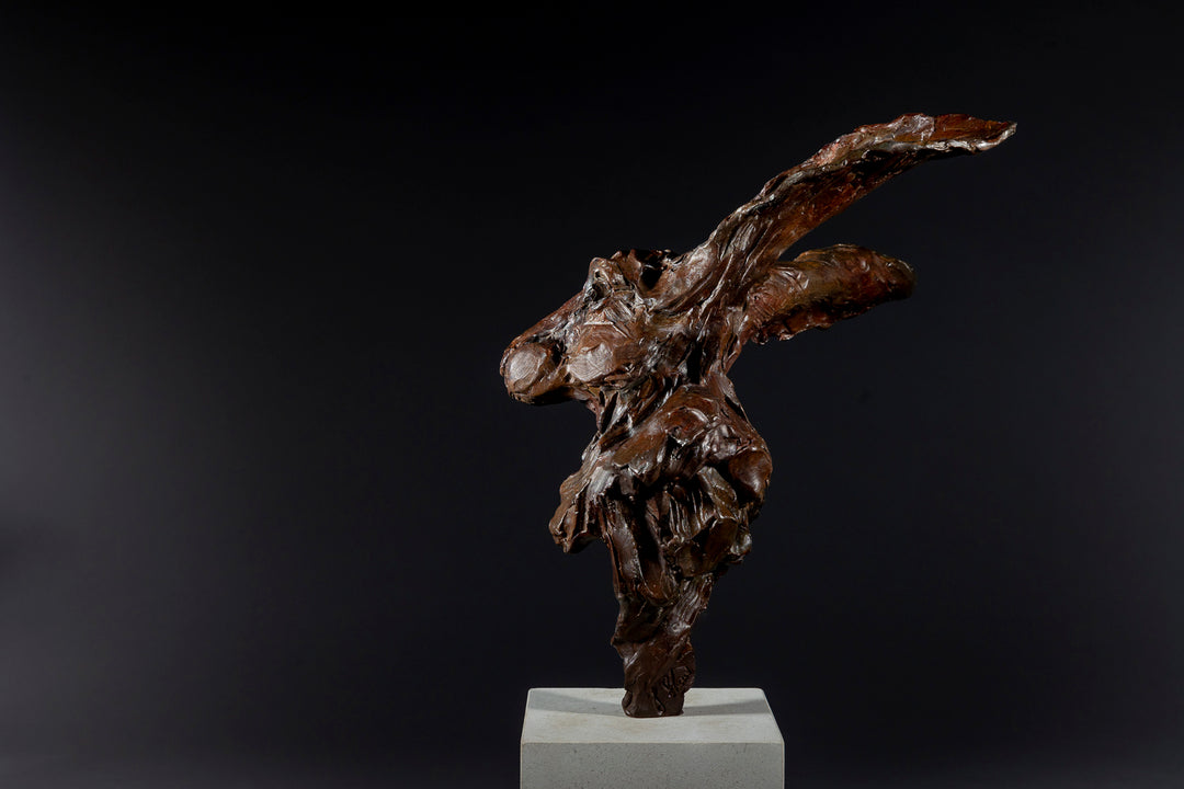 Expressive bronze sculpture of a hare’s head with exaggerated upright ears, mounted on a smooth Portland stone base.