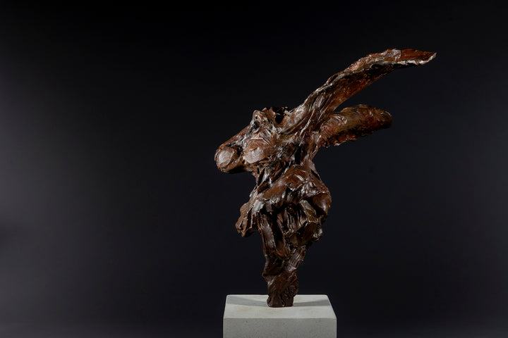 Expressive bronze sculpture of a hare’s head with exaggerated upright ears, mounted on a smooth Portland stone base.