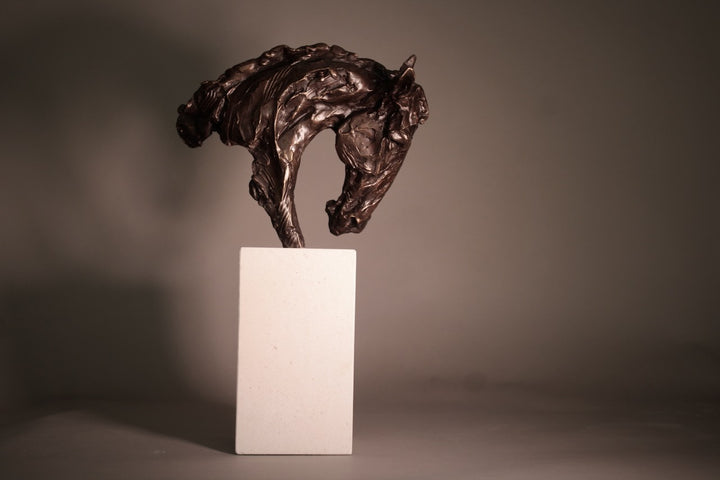 Bronze sculpture of an arched horse head with expressive detailing, mounted on a minimalist Portland stone base against a soft neutral backdrop.