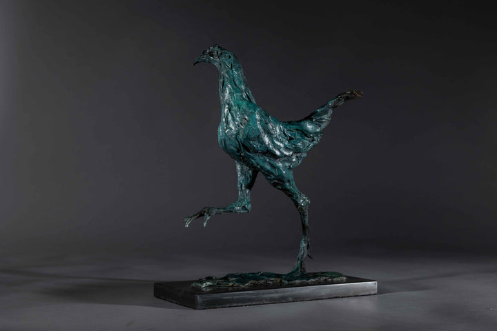 Bronze sculpture of a proud gaming cockerel mid-stride, with elongated legs and intricate feather textures, finished in a rich verdigris patina, mounted on a slate base.