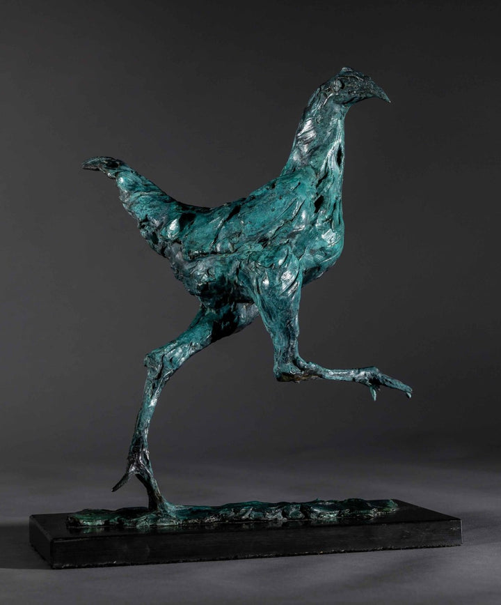 Bronze sculpture of a proud gaming cockerel mid-stride, with elongated legs and intricate feather textures, finished in a rich verdigris patina, mounted on a slate base.