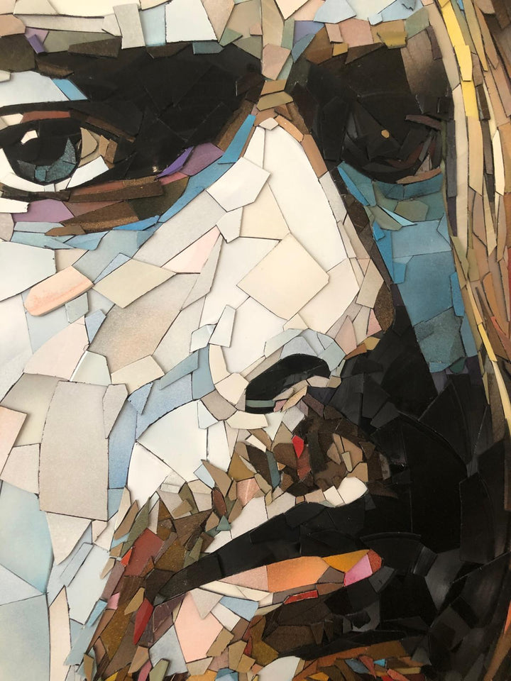 Ed Chapman mosaic portrait of Kurt Cobain crafted entirely from broken vinyl records, with layered shards forming a striking likeness of the Nirvana frontman against a soft pink background.