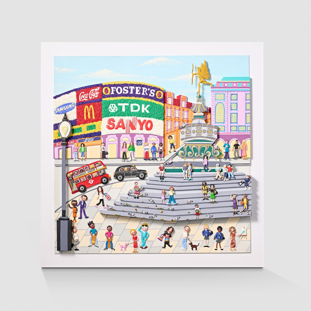 A vibrant, three-dimensional polymer clay artwork of Piccadilly Circus, featuring the iconic curved billboard with brands like Coca-Cola, McDonald’s, and TDK rendered in colourful textured beads. The street scene below includes a classic red double-decker bus marked “38 Piccadilly Circus,” a London black cab, and crowds of joyful figures in bright handmade outfits. Sculpted pigeons dot the grey stone steps beneath the Shaftesbury Memorial Fountain with a golden winged Eros above. 
