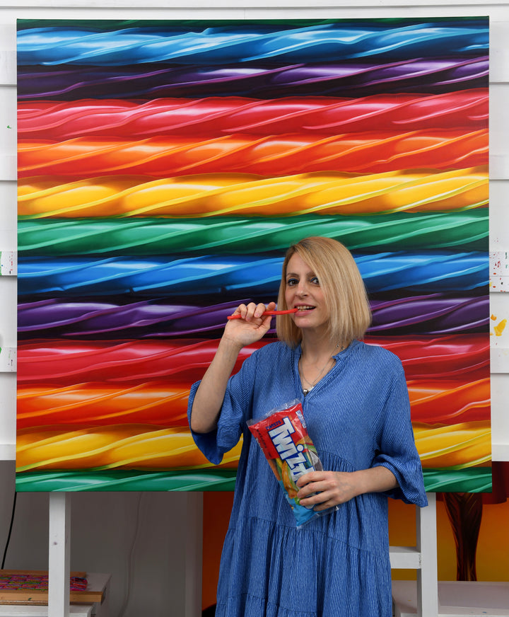 Kelly-Anne Davitt Twisted Rainbow hyperreal oil painting on linen depicting glossy twisted rainbow sweets flowing in bands of red, orange, yellow, green, blue and purple across the canvas.