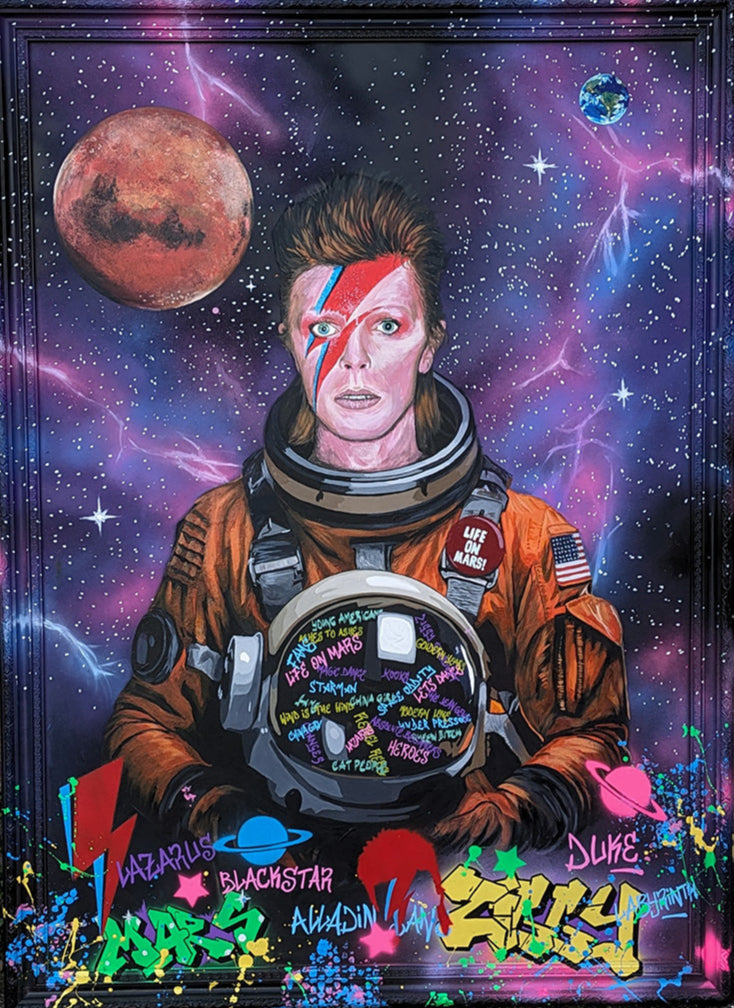 Limited edition embellished art print of David Bowie in a retro orange NASA-style spacesuit set against a vivid cosmic backdrop, featuring Mars and Earth, graffiti elements, and Bowie’s iconic lightning bolt makeup, created by KiPS.art and printed on 3mm Foamex.