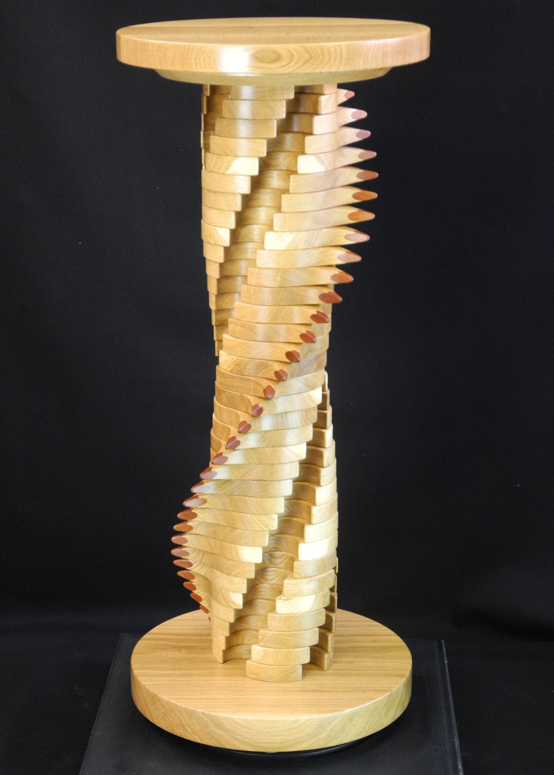 Lacuna Table 2 by Max McCance — a one-off sculptural table in oak and mahogany with a twisting double-helix column and sharp mahogany points spiralling upward beneath a round oak top and base.