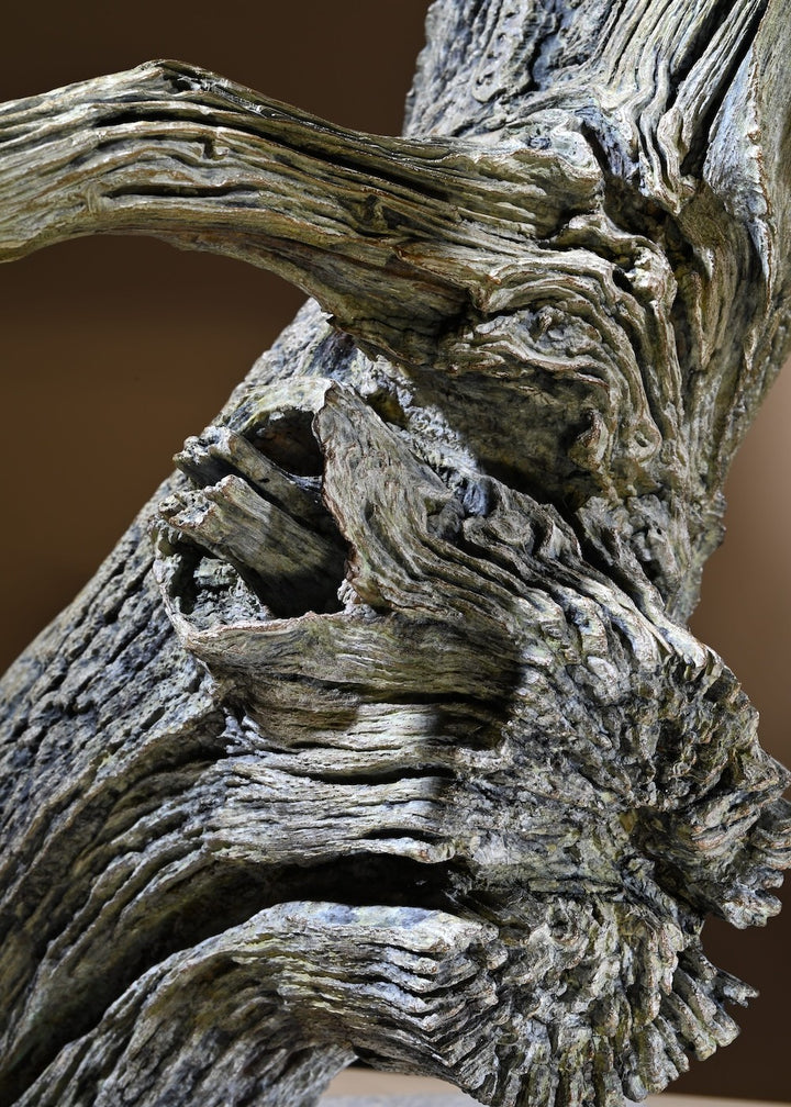 ‘Leopard Climbing Down a Tree’ by Hamish Mackie, a limited-edition bronze wildlife sculpture depicting an African leopard descending headfirst down a tall, weathered tree trunk. The leopard's muscular body, extended forelegs and curved tail capture the animal's extraordinary agility and balance. Finished in natural earthy bronze tones, the sculpture features a highly textured tree trunk mounted on a rectangular Purbeck limestone base, inspired by the artist's wildlife observations in the Serengeti.