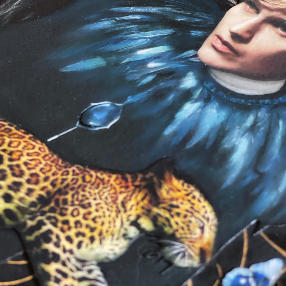 Catarina Diaz’s Let Me Hold You, analogue collage on Somerset Enhanced Velvet with oil on gesso-primed canvas. Blonde man in black with blue feathered collar, crowned crane, leopard, and blue butterfly, set against a deep black backdrop with gold accents.