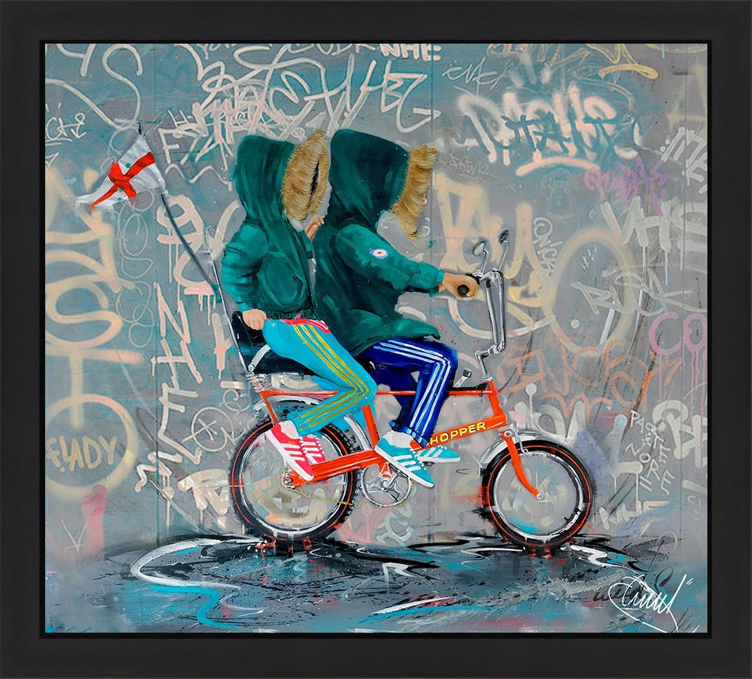CROGGY CHOPPER GRAFFITI by Wild Seeley — limited edition framed hand-finished canvas print of two hooded kids riding a bright red Raleigh Chopper bike against a graffiti-covered urban wall, with vibrant Adidas stripes and splashes of teal, orange, and grey.