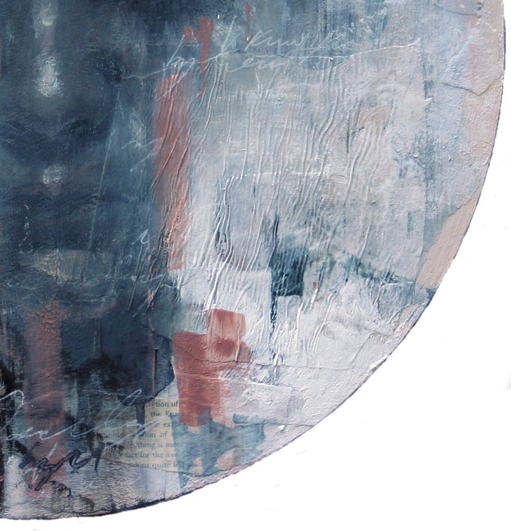 A moody, ethereal mixed media painting by Toni Cogdell on a circular wood panel. Layers of acrylic, oil paint, and collage materials form a soft, ghost-like portrait that seems to emerge from and dissolve into the surface. Tones of charcoal grey, rose, cream, and pale blue are applied with expressive texture and gestural marks, creating a mysterious, almost dreamlike presence. Subtle botanical impressions and abstract forms weave through the surface, adding to the artwork’s sense of quiet contemplation.