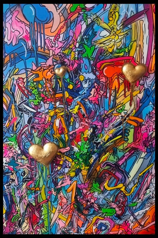 A vibrant mixed-media abstract artwork filled with layered graffiti-style lines, drips and splashes in bright pinks, blues, yellows and greens, featuring three raised gold 3D heart elements floating within the composition, framed in a black tray frame.