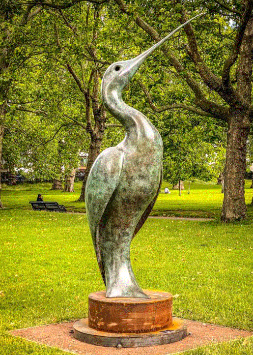 Simon Gudgeon bronze sculpture Luna featuring an elegant abstract curlew-inspired bird form with sweeping curved lines displayed within landscaped garden settings.
