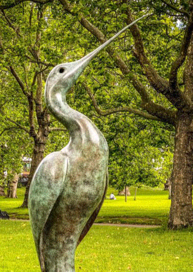 Simon Gudgeon bronze sculpture Luna featuring an elegant abstract curlew-inspired bird form with sweeping curved lines displayed within landscaped garden settings.