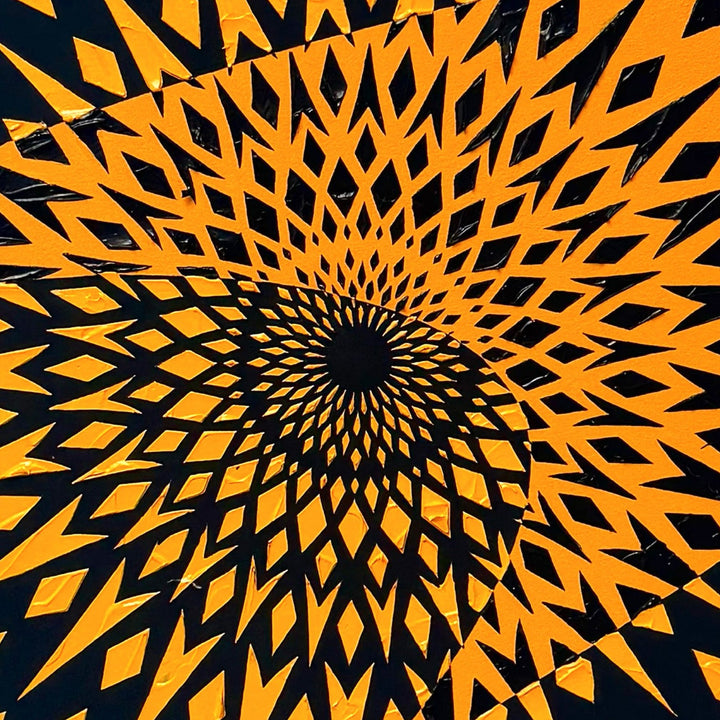 High-impact circular wall artwork by Mike Philp featuring sharp orange geometric forms radiating from the centre against a dark ground. Inspired by Formula 1, the composition expresses speed, precision, and engineered motion.