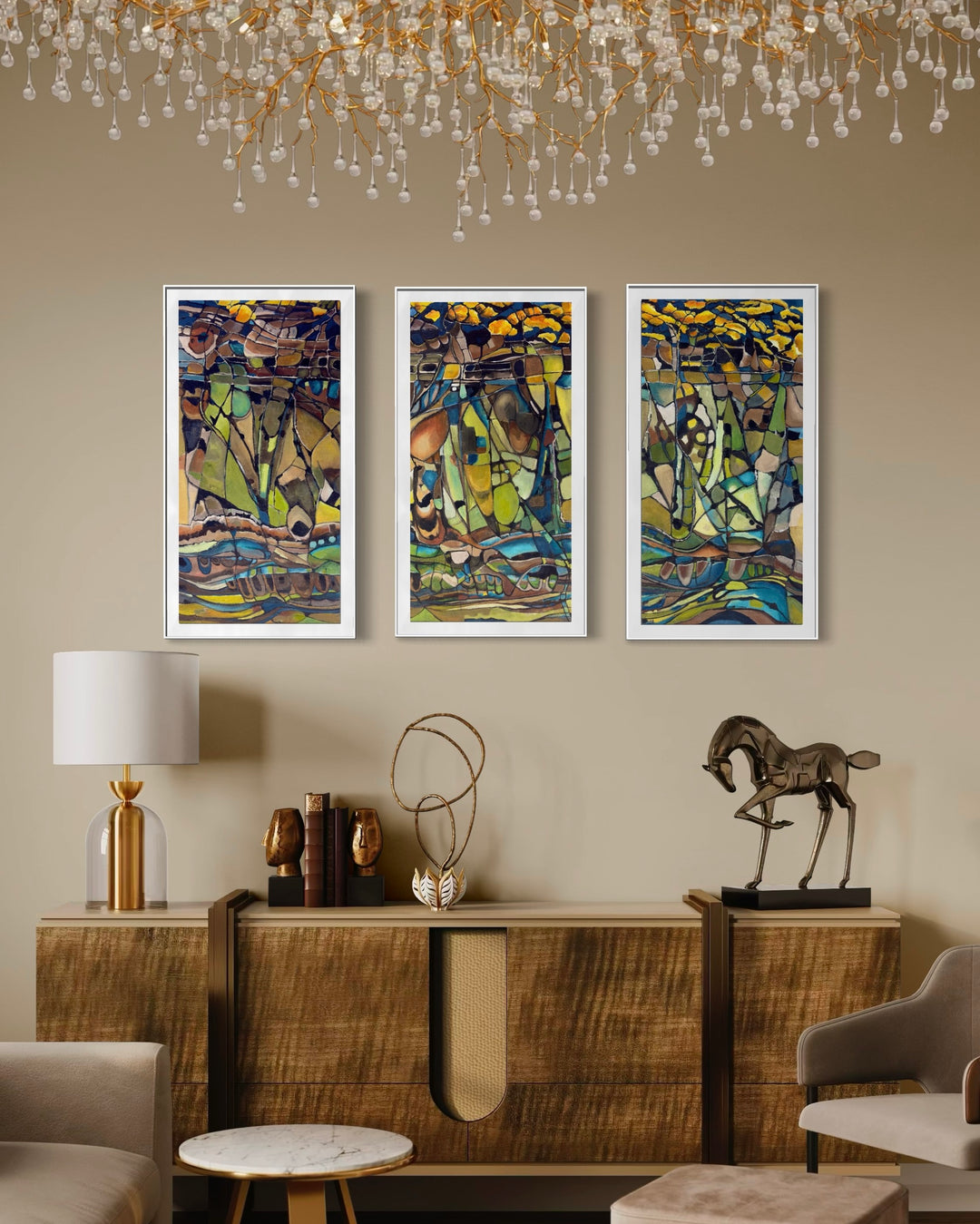 Kate Grant Metamorphosis triptych abstract landscape painting in three vertical panels, inspired by the shale formations of Crooklets Beach in North Cornwall. Fragmented, mosaic-like shapes in layered acrylic create a flowing geological composition, with deep blues, earthy browns and greens shifting into warm amber and golden tones, evoking rock, tide and time across a continuous, evolving coastal scene.