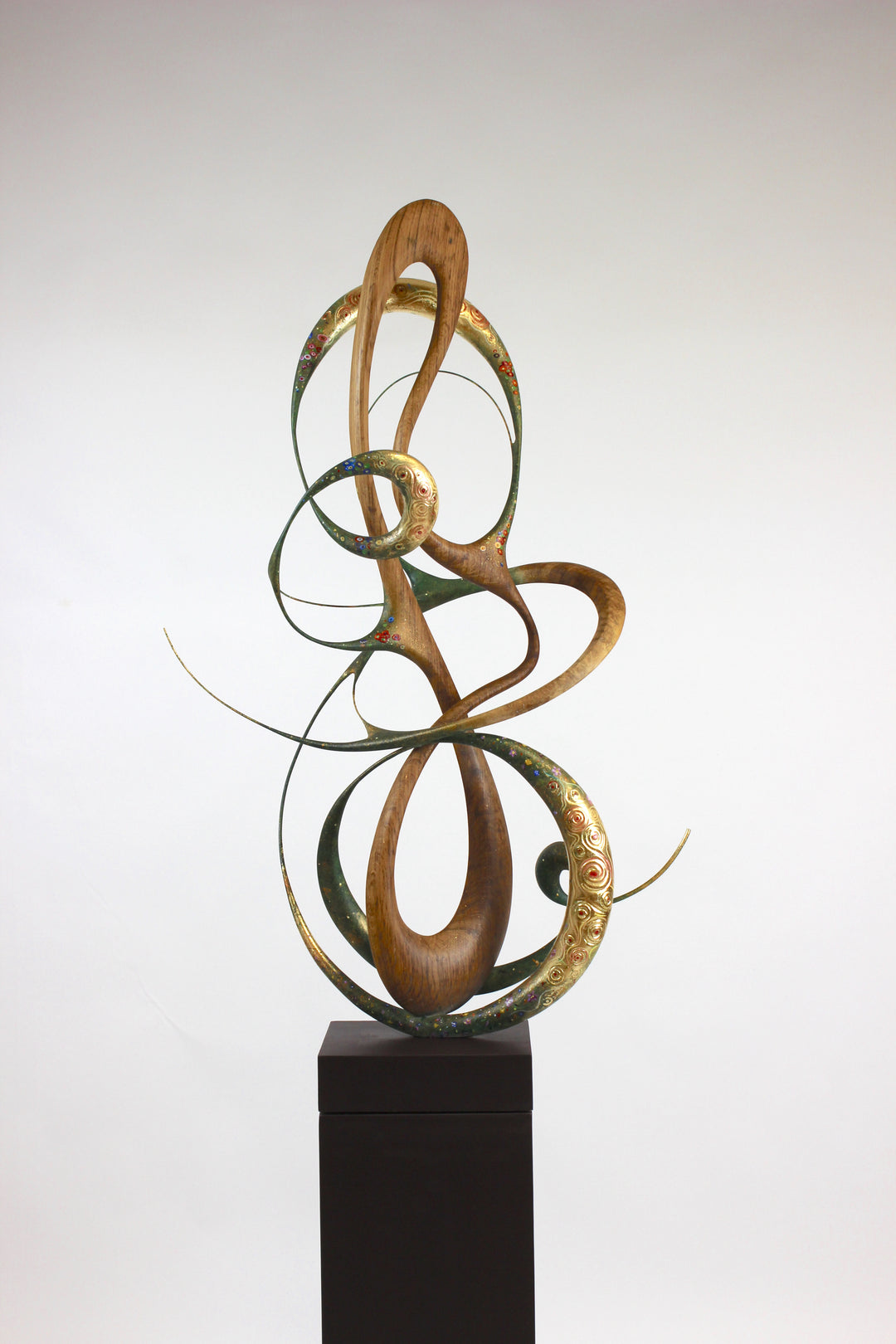 How Was I to Know by Mark Purllant, a one-off mixed media sculpture in carved English brown oak with intertwining flowing forms, enriched with painted details and 23ct gold leaf accents, evoking Gustav Klimt’s decorative influence.