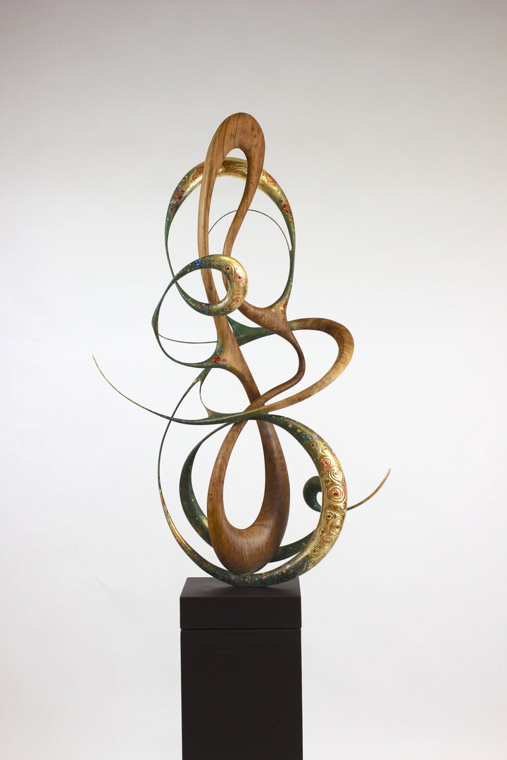 How Was I to Know by Mark Purllant, a one-off mixed media sculpture in carved English brown oak with intertwining flowing forms, enriched with painted details and 23ct gold leaf accents, evoking Gustav Klimt’s decorative influence.