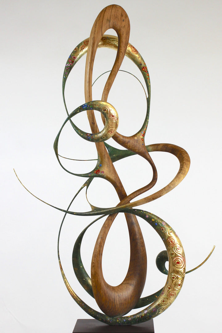 How Was I to Know by Mark Purllant, a one-off mixed media sculpture in carved English brown oak with intertwining flowing forms, enriched with painted details and 23ct gold leaf accents, evoking Gustav Klimt’s decorative influence.
