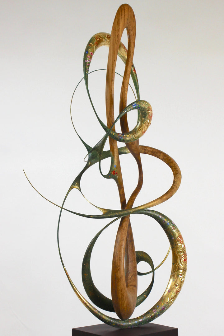How Was I to Know by Mark Purllant, a one-off mixed media sculpture in carved English brown oak with intertwining flowing forms, enriched with painted details and 23ct gold leaf accents, evoking Gustav Klimt’s decorative influence.