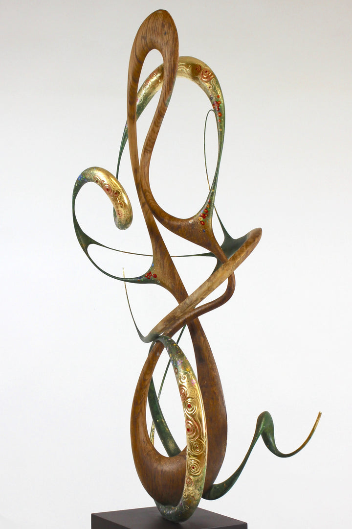 How Was I to Know by Mark Purllant, a one-off mixed media sculpture in carved English brown oak with intertwining flowing forms, enriched with painted details and 23ct gold leaf accents, evoking Gustav Klimt’s decorative influence.