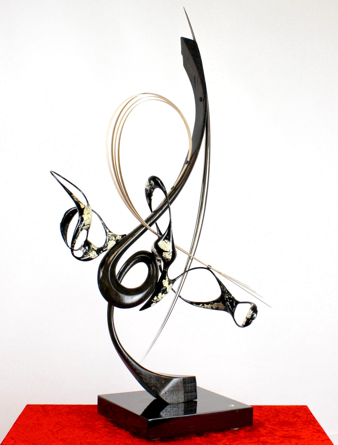 Katana by Mark Purllant, a one-off mixed media sculpture crafted from ancient bog oak with black Japanning and eggshell inlay, combined with whitened maple veneer and polished stainless steel, evoking Japanese elegance and controlled strength.