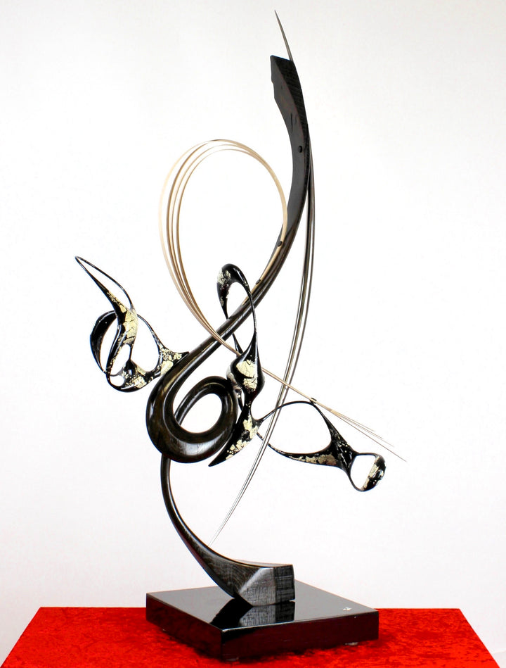 Katana by Mark Purllant, a one-off mixed media sculpture crafted from ancient bog oak with black Japanning and eggshell inlay, combined with whitened maple veneer and polished stainless steel, evoking Japanese elegance and controlled strength.