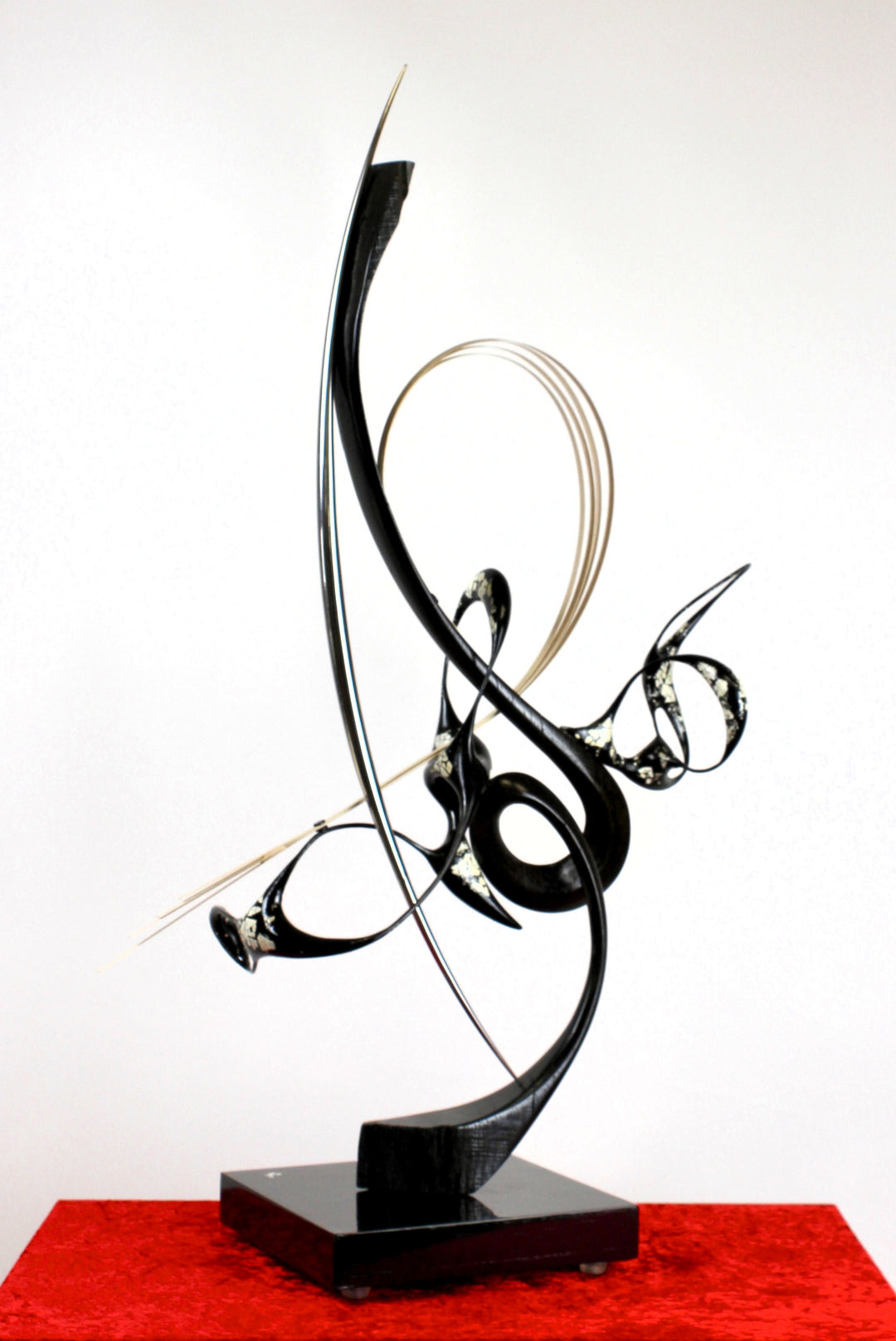 Katana by Mark Purllant, a one-off mixed media sculpture crafted from ancient bog oak with black Japanning and eggshell inlay, combined with whitened maple veneer and polished stainless steel, evoking Japanese elegance and controlled strength.