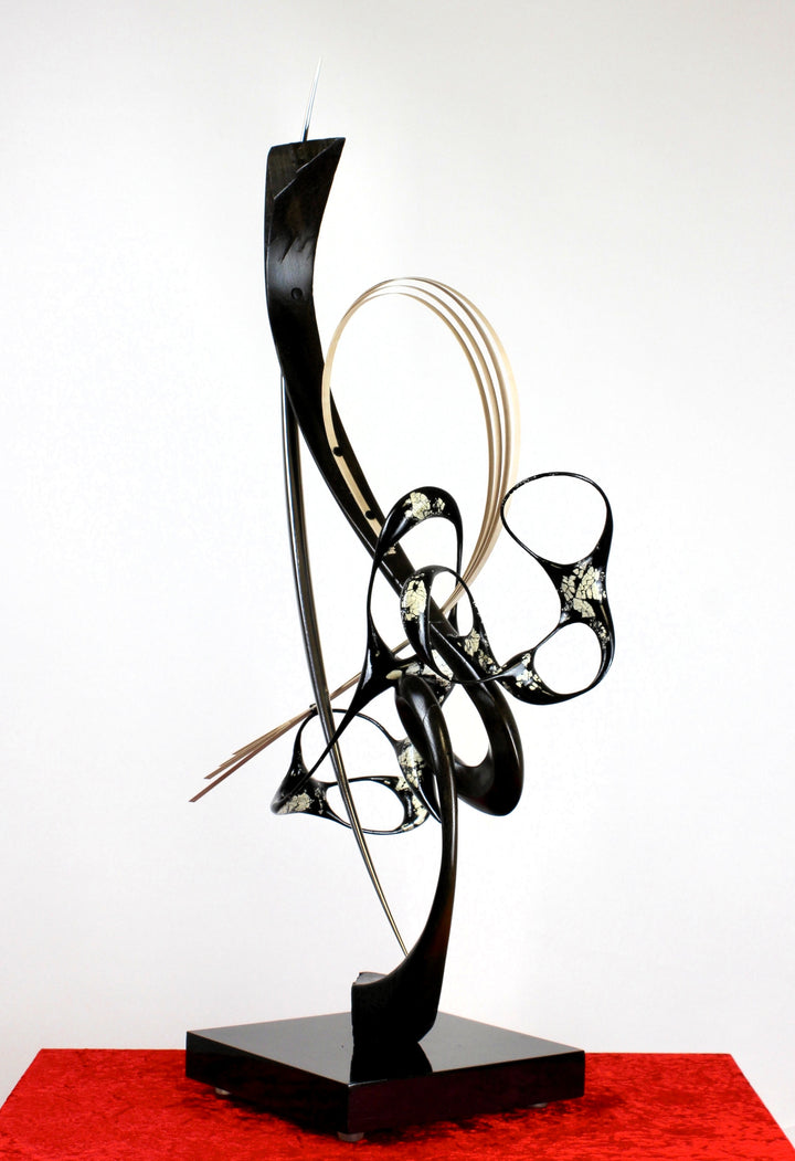 Katana by Mark Purllant, a one-off mixed media sculpture crafted from ancient bog oak with black Japanning and eggshell inlay, combined with whitened maple veneer and polished stainless steel, evoking Japanese elegance and controlled strength.