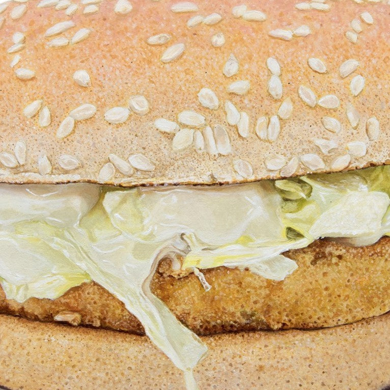Simon Taylor, McChicken® Sandwich, oil on linen, 35 x 35cm – hyperrealistic painting of a sesame seed bun filled with coated chicken patty and pale green iceberg lettuce, set against a clean white ground.