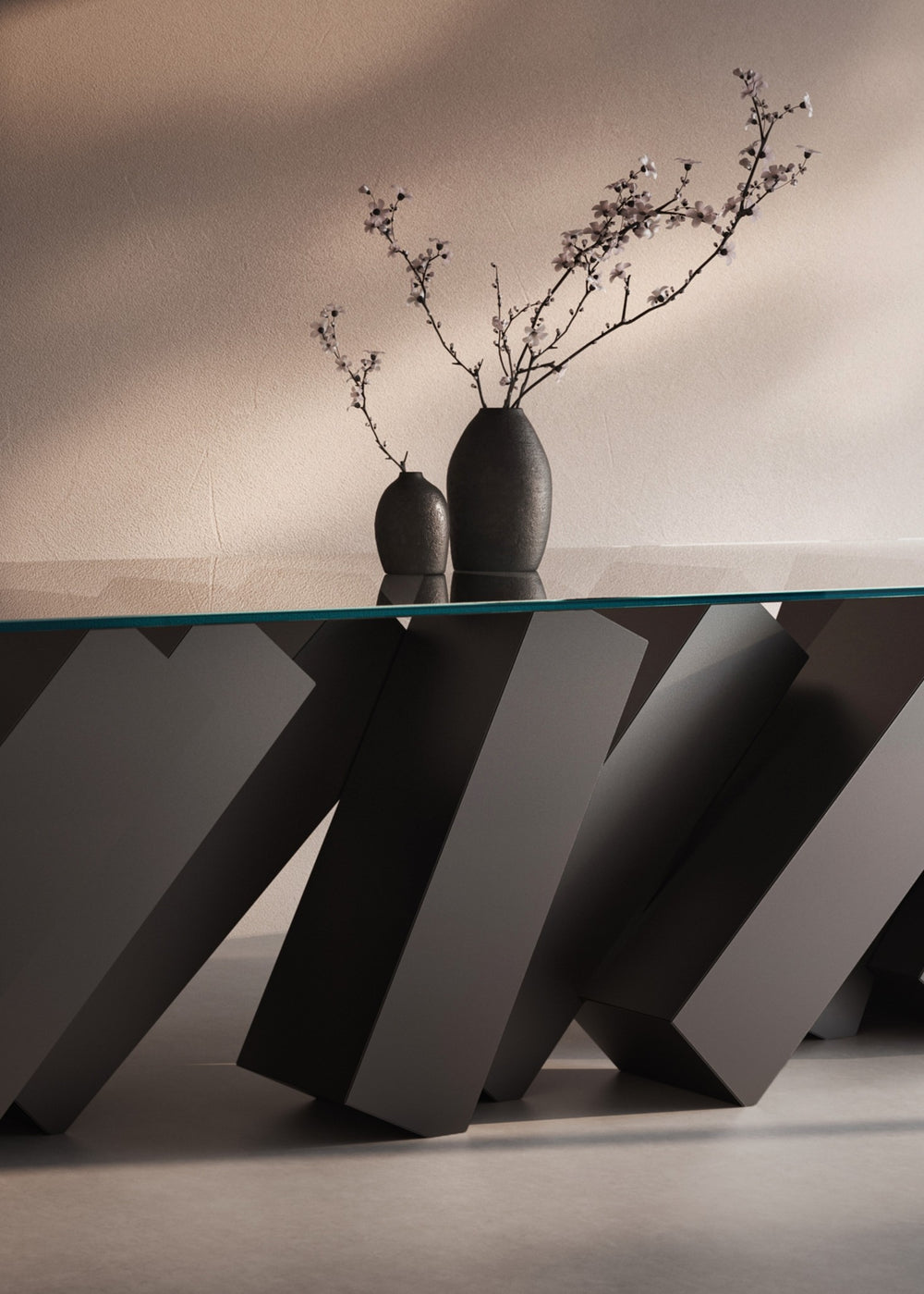 Duffy London Megalith Dining Table with angled black monolithic base and clear glass top, creating a gravity-defying illusion of collapsing architectural forms.
