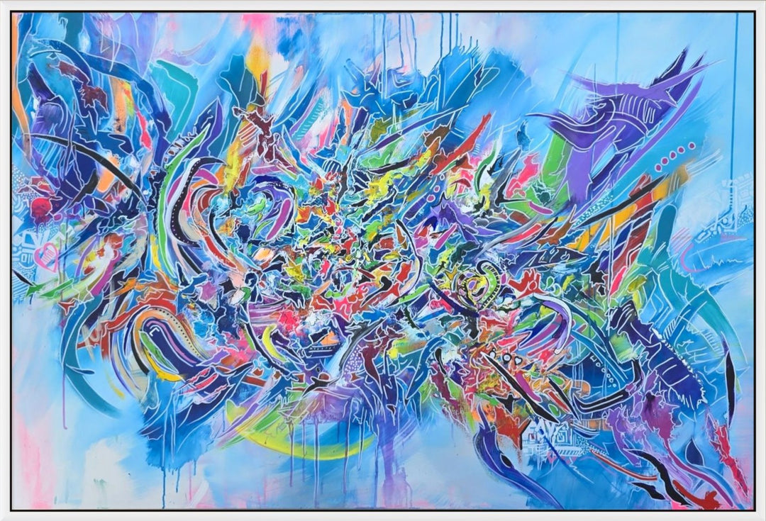 Vibrant large-scale abstract graffiti painting bursting with layered colour, bold sweeping lines and dynamic shapes against a bright blue background, framed in a white tray frame.