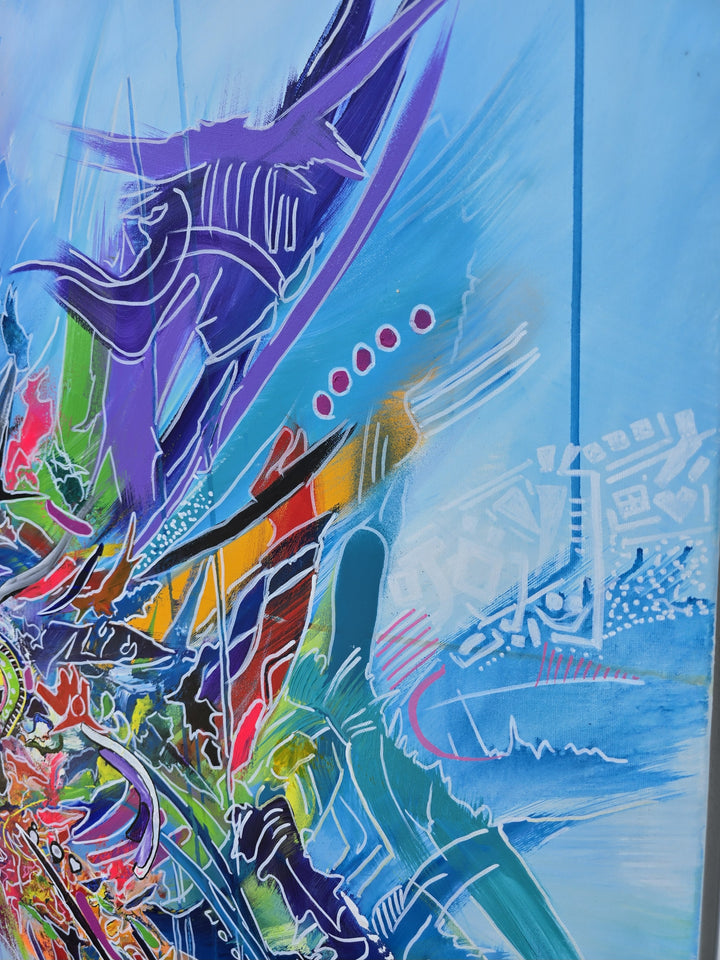 Vibrant large-scale abstract graffiti painting bursting with layered colour, bold sweeping lines and dynamic shapes against a bright blue background, framed in a white tray frame.